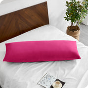 A body pillowcase on a pillow on a bed with all white bedding