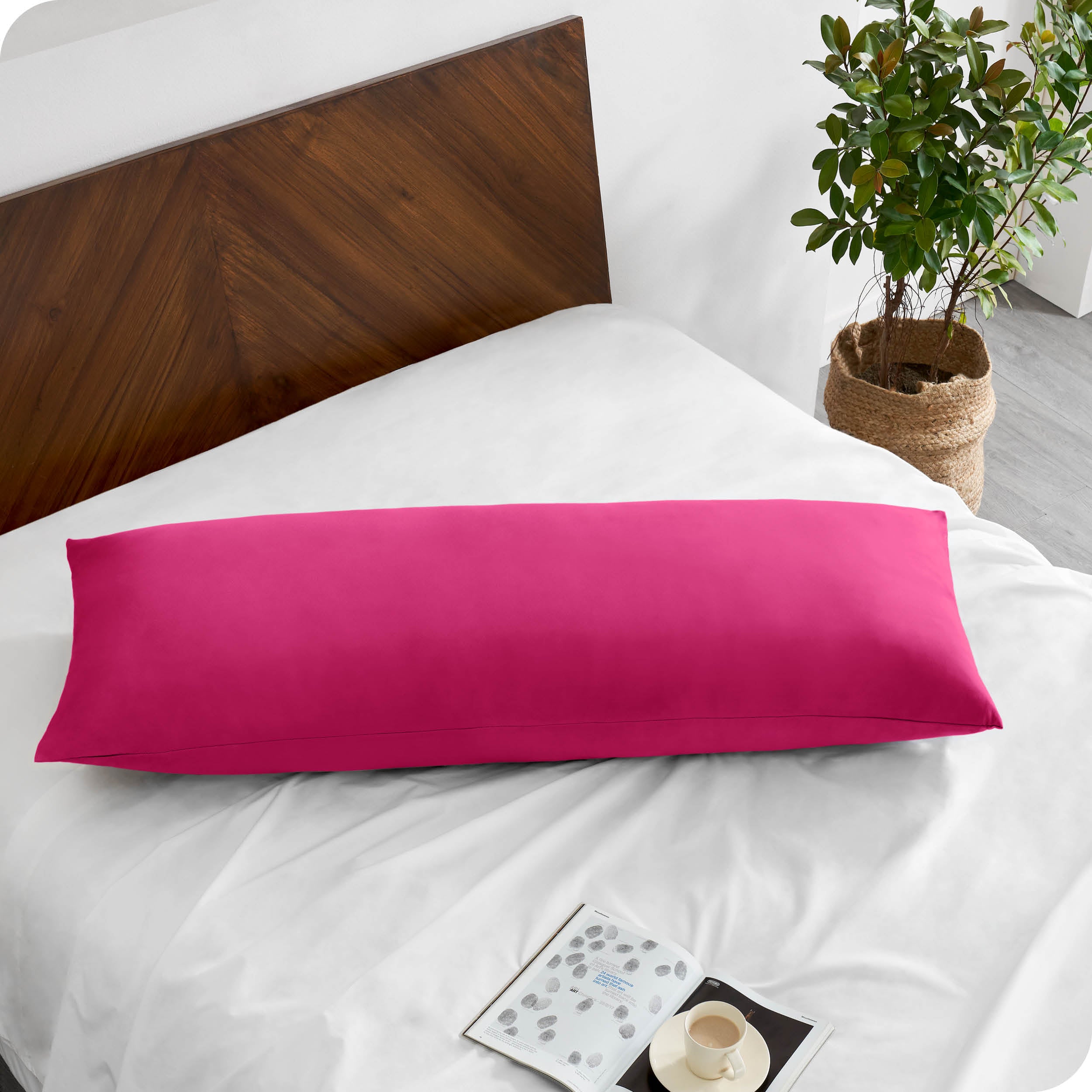 A body pillowcase on a pillow on a bed with all white bedding