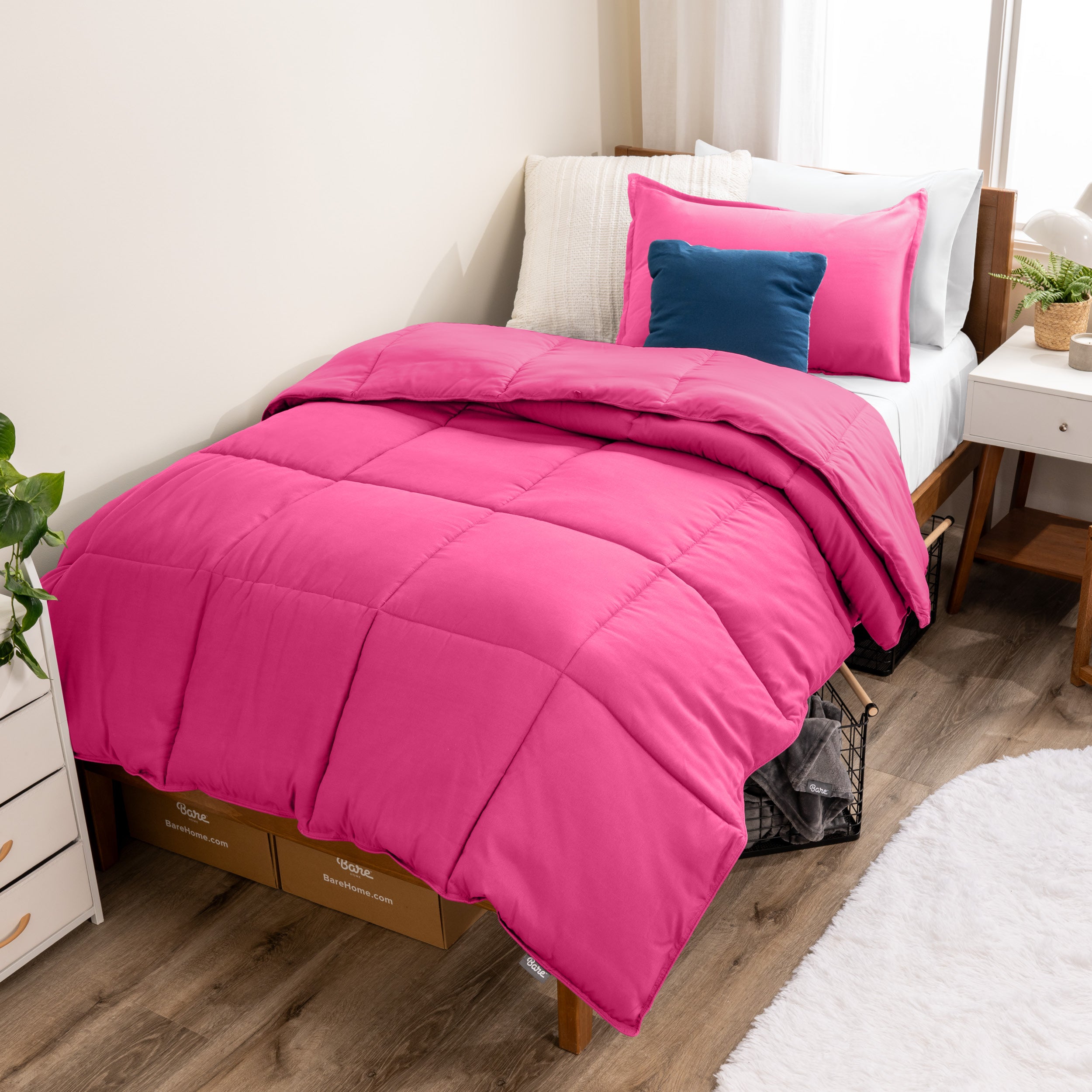 A modern bed with a down alternative comforter set on it