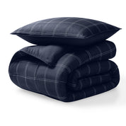 A microfiber comforter folded neatly with a pillow from above