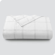 Neatly folded printed microfiber flat sheet with corner folded over. 