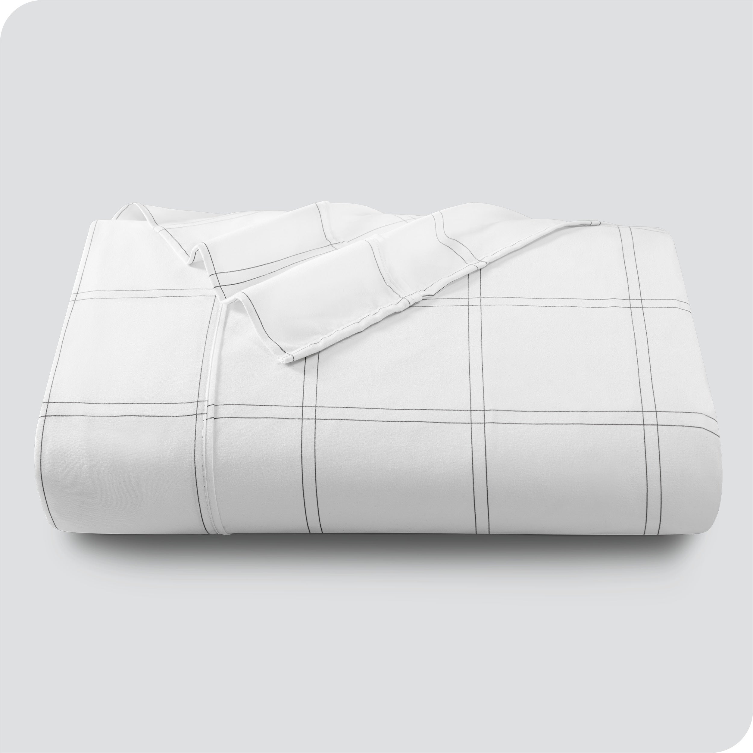 Neatly folded printed microfiber flat sheet with corner folded over. 