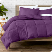 A wooden bed frame with sheets, pillow shams and a comforter on the bed