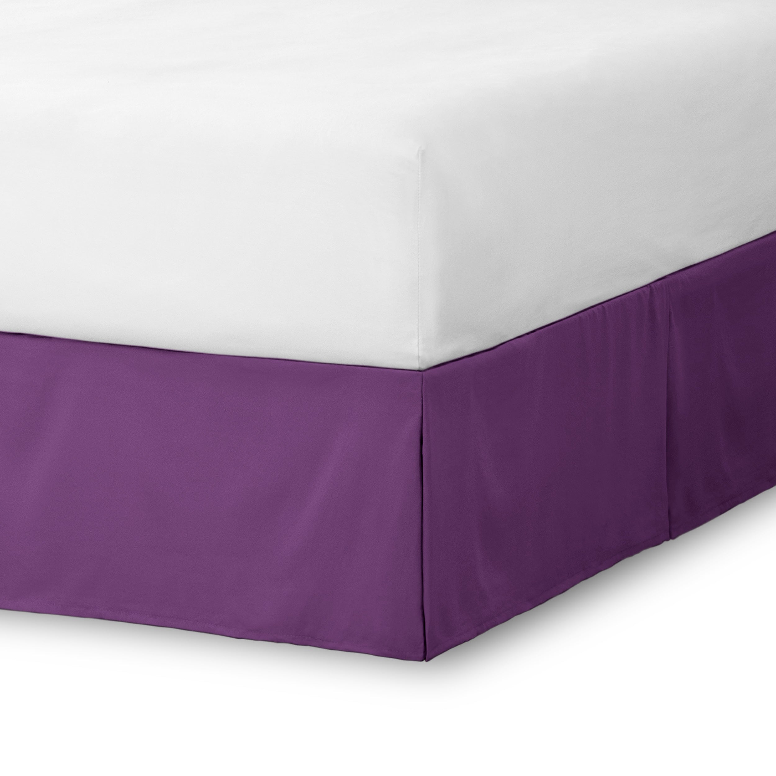 The corner of a bed skirt on a bed frame