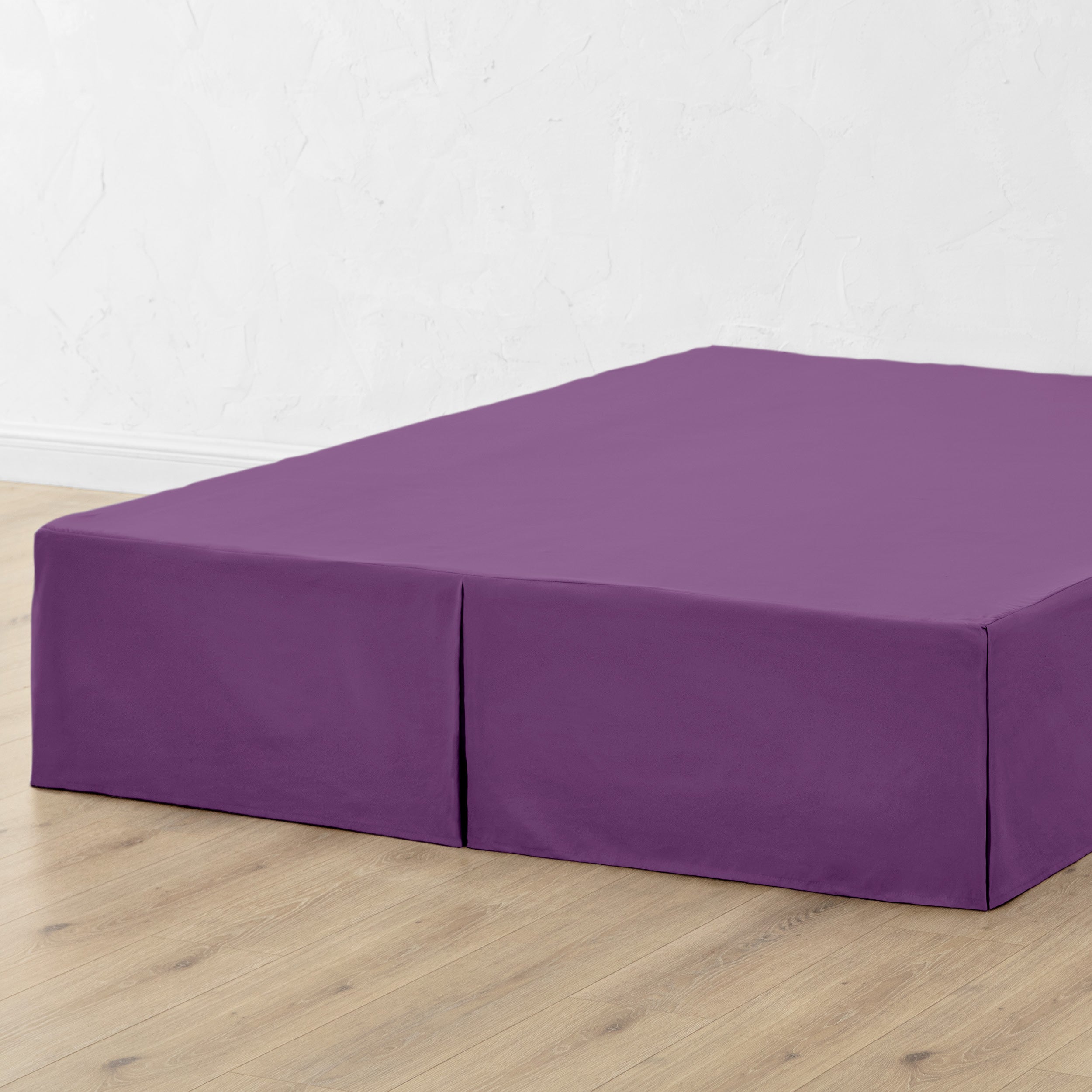 A bed skirt draped over a box spring