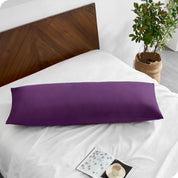 A body pillowcase on a pillow on a bed with all white bedding