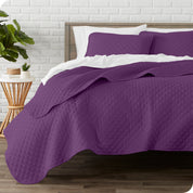 A quilted coverlet set on a bed