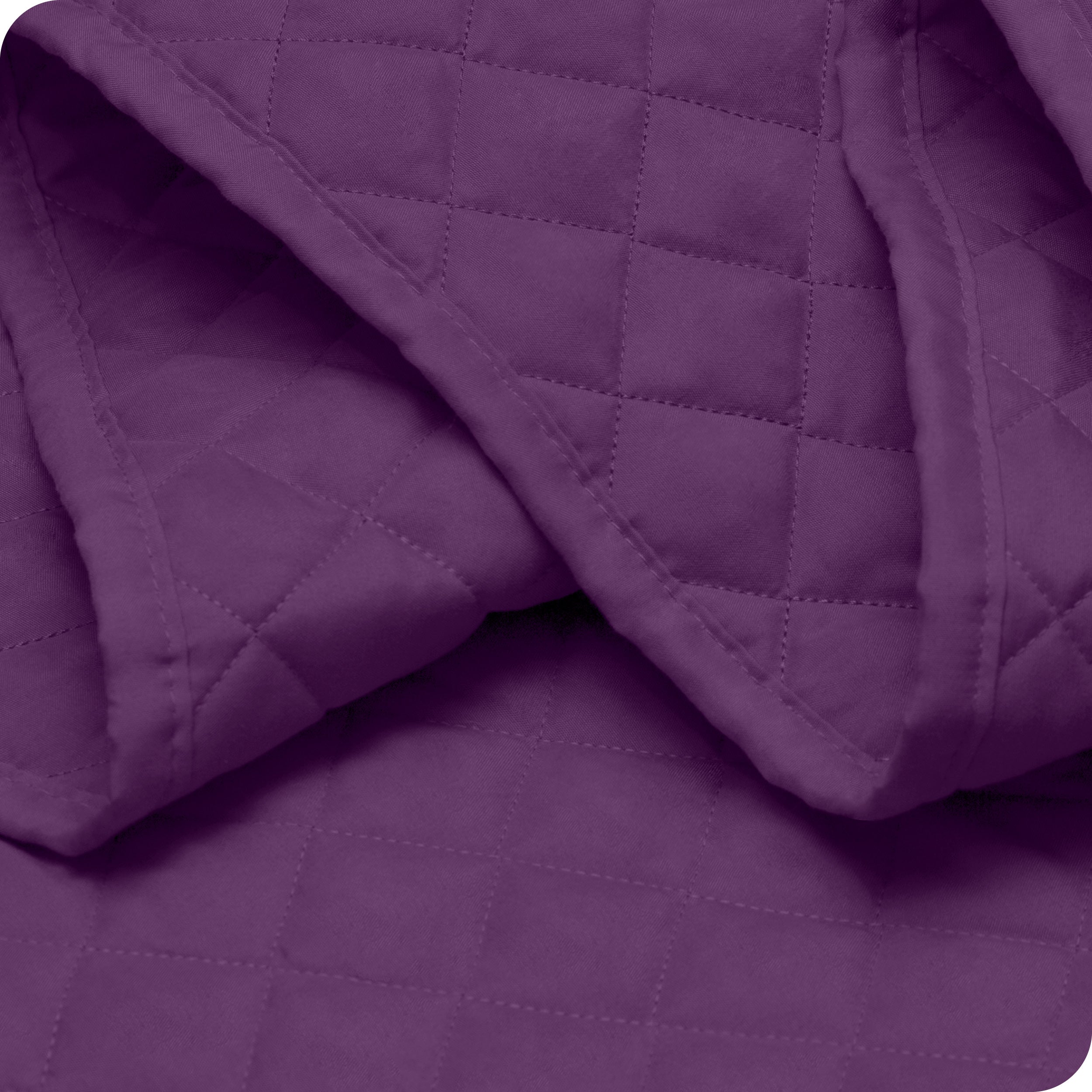 Close up of a coverlet showing the stitching
