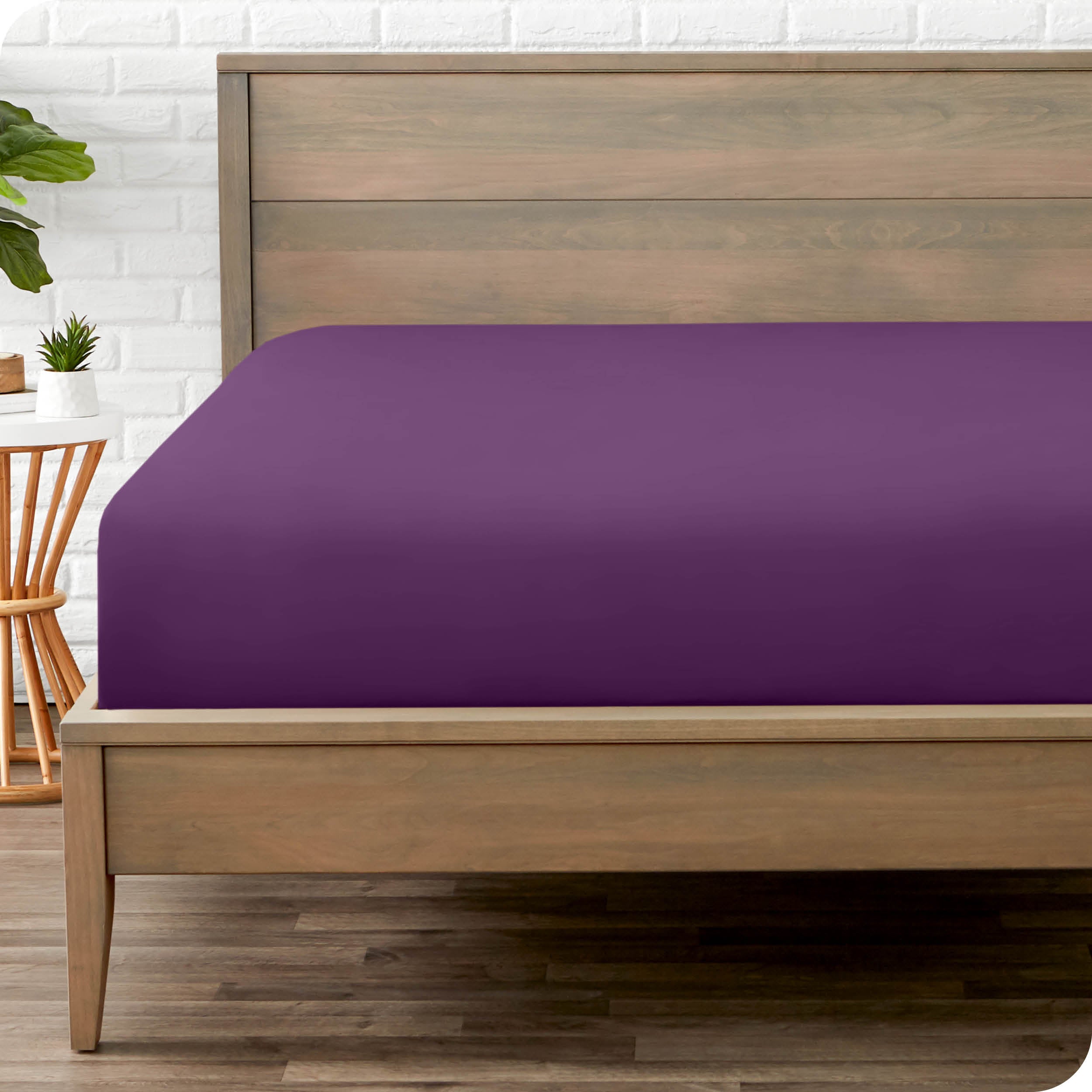 End of bed view with fitted sheet made on the mattress of a modern bed. 