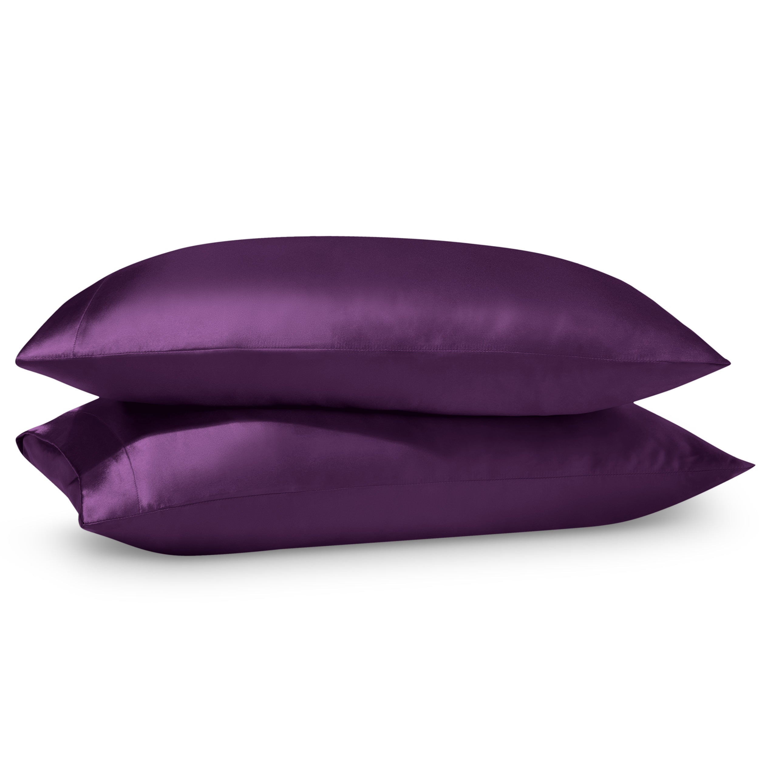 Two pillows on a white background with satin pillowcases on them.