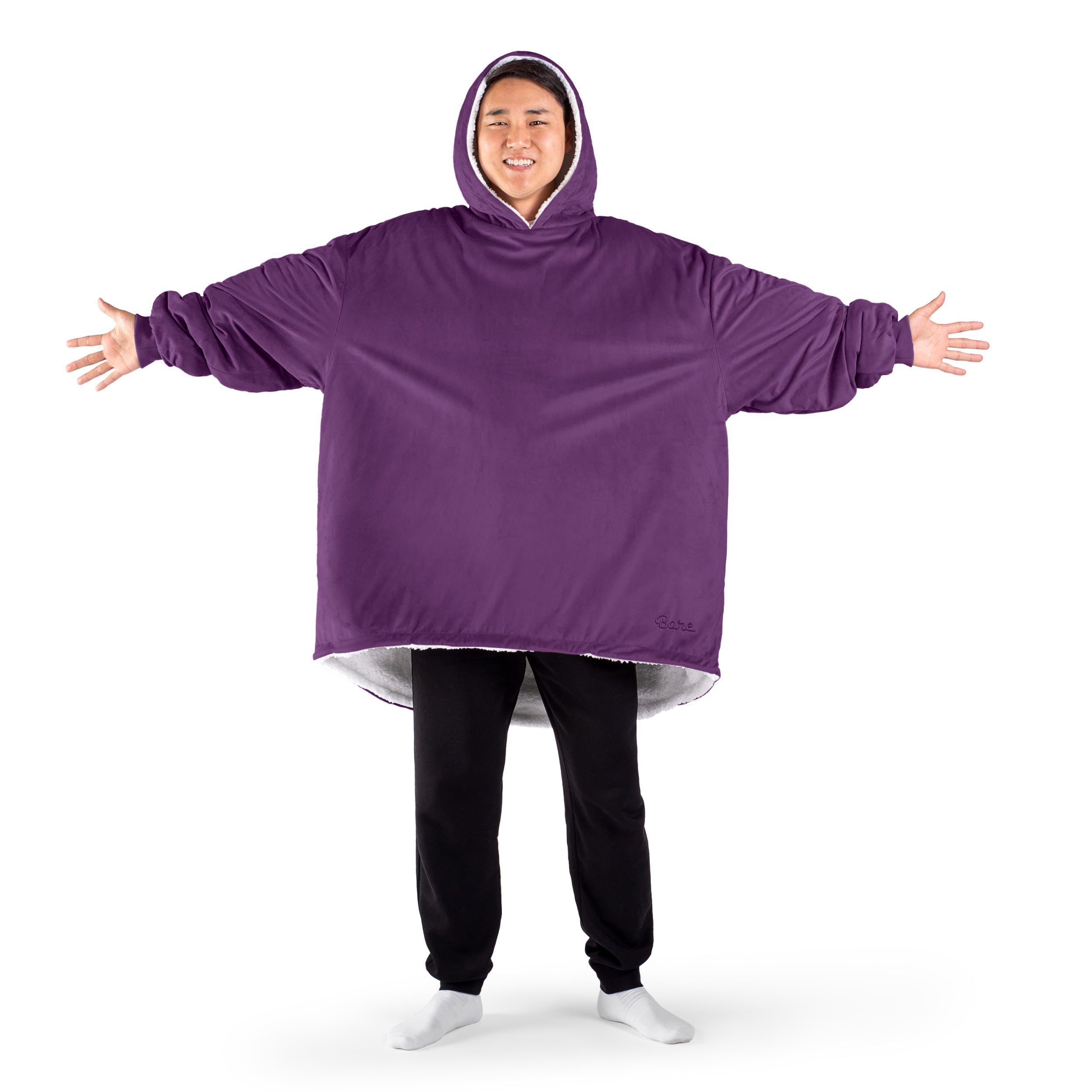 An adult with a sherpa wearable blanket on