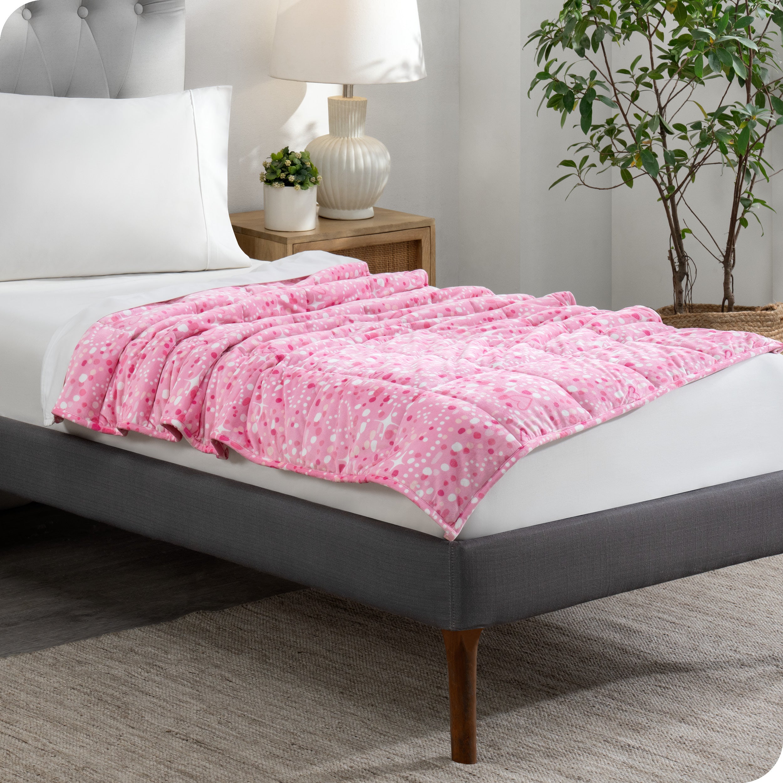 A weighted blanket laid out on a bed