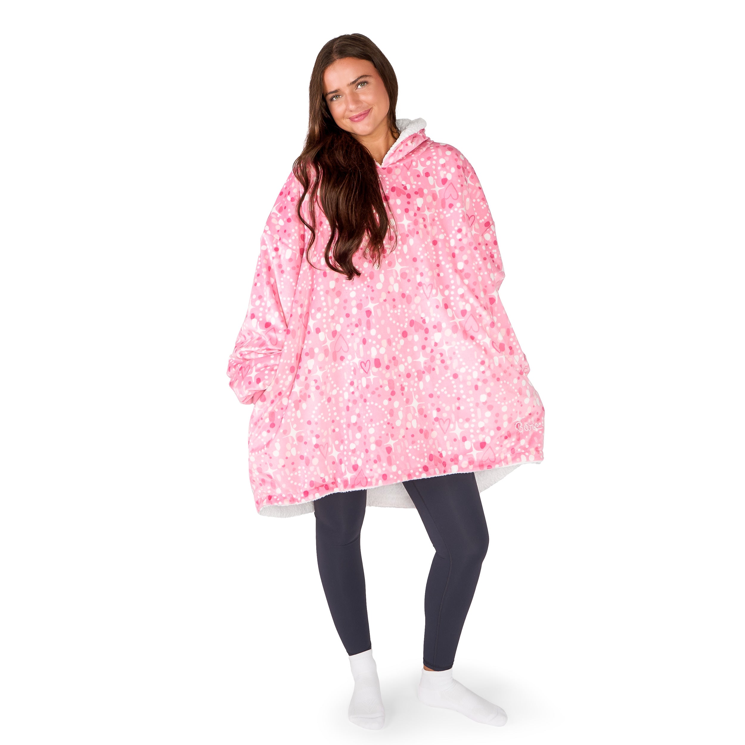 An adult with a hooded wearable blanket on