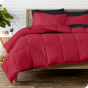 A wooden bed frame with sheets, pillow shams and a comforter on the bed