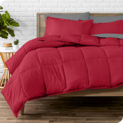 A wooden bed frame with sheets, pillow shams and a comforter on the bed