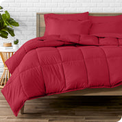 A wooden bed frame with sheets, pillow shams and a comforter on the bed
