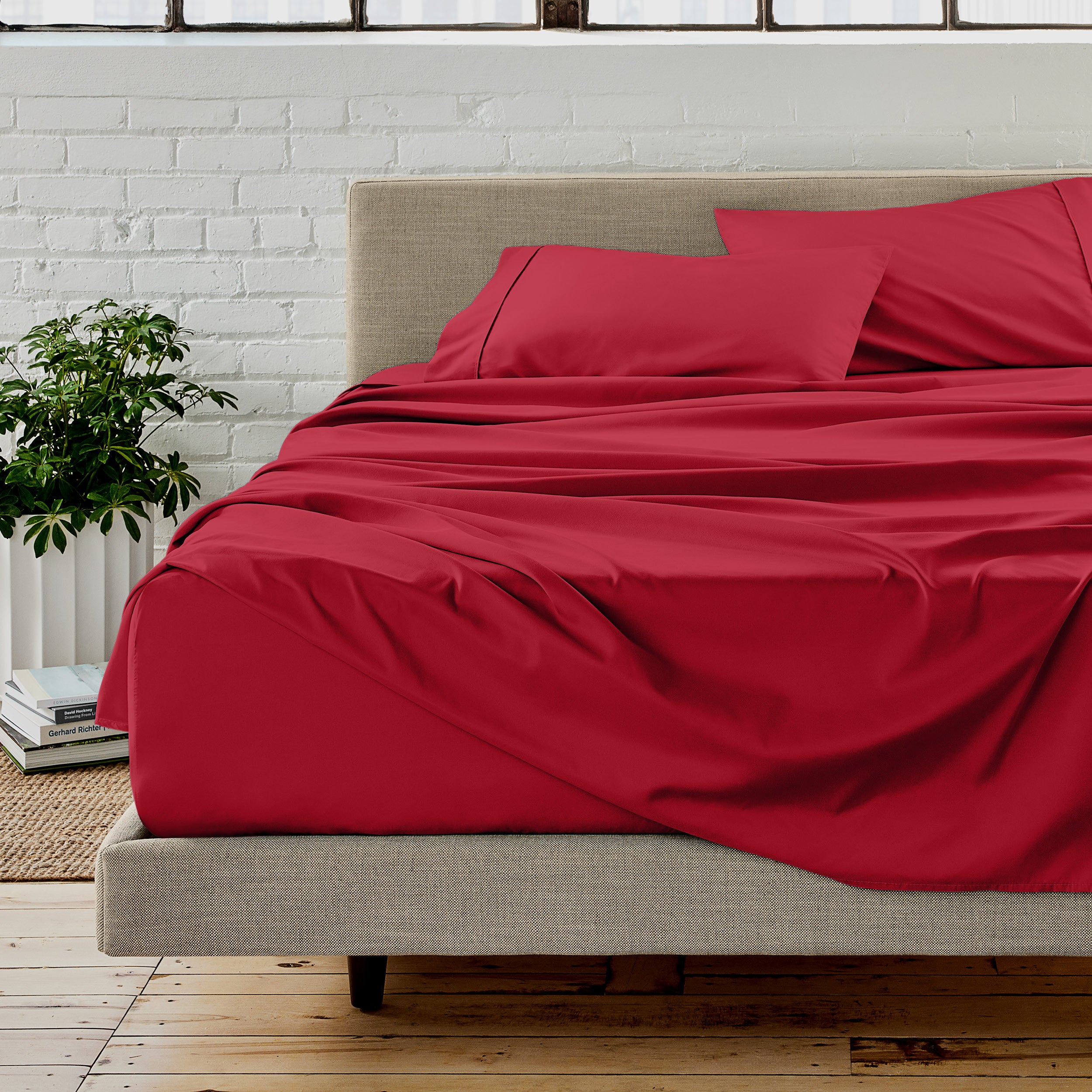 Microfiber sheet set on a bed with a white brick wall in the background