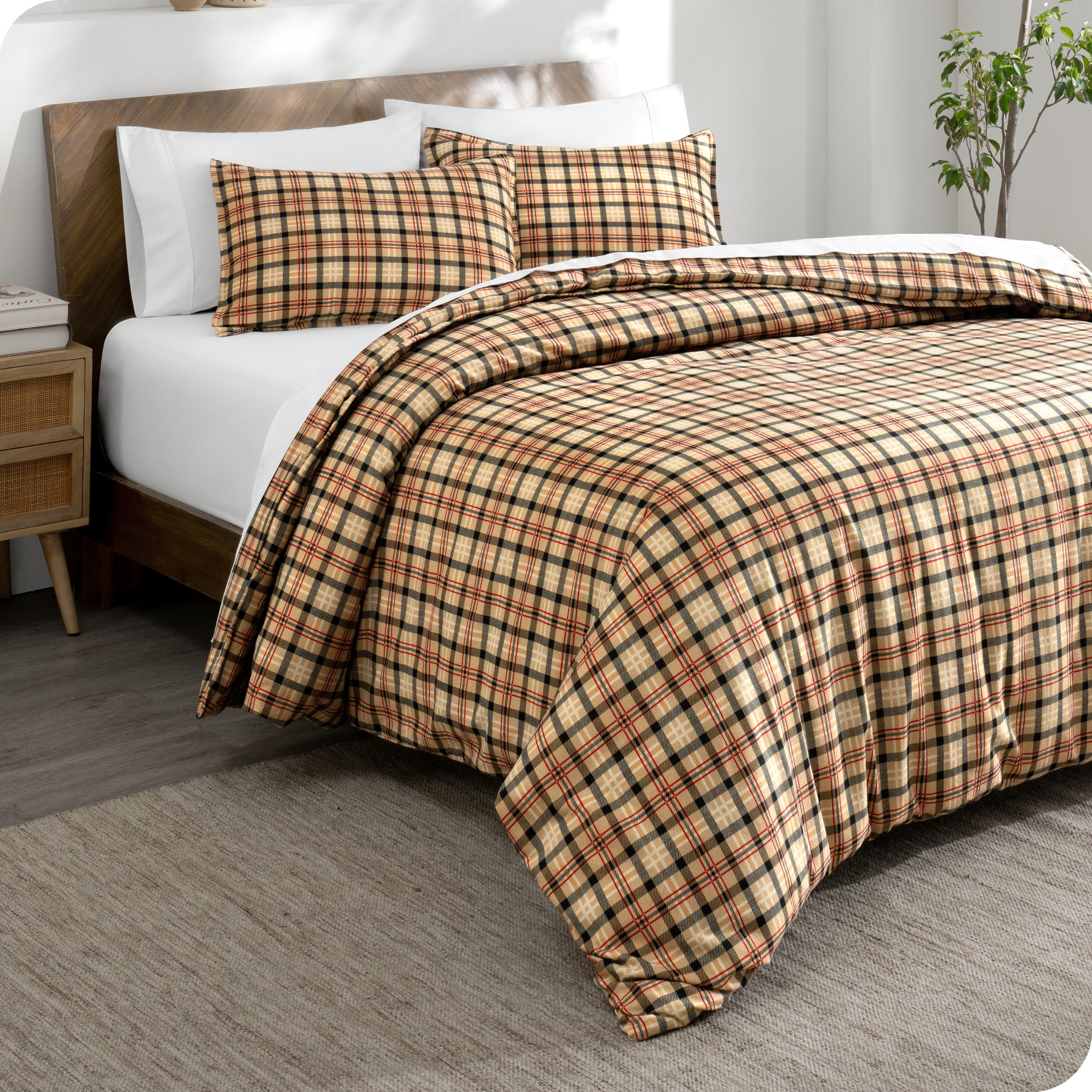 A side view of a bed with a flannel duvet cover set on it.
