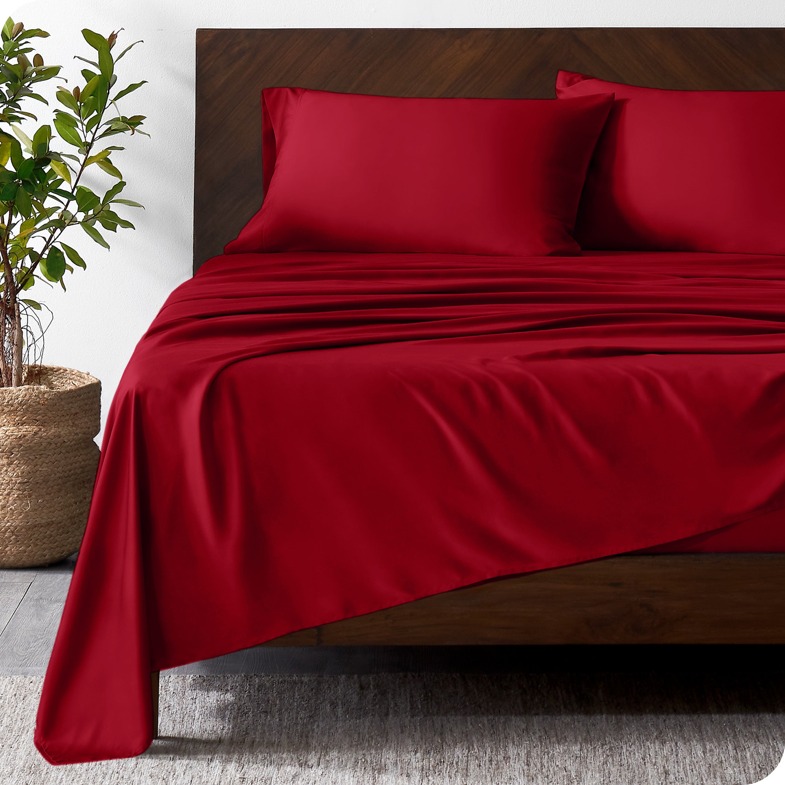 Wooden bed frame with bamboo sheets on the bed