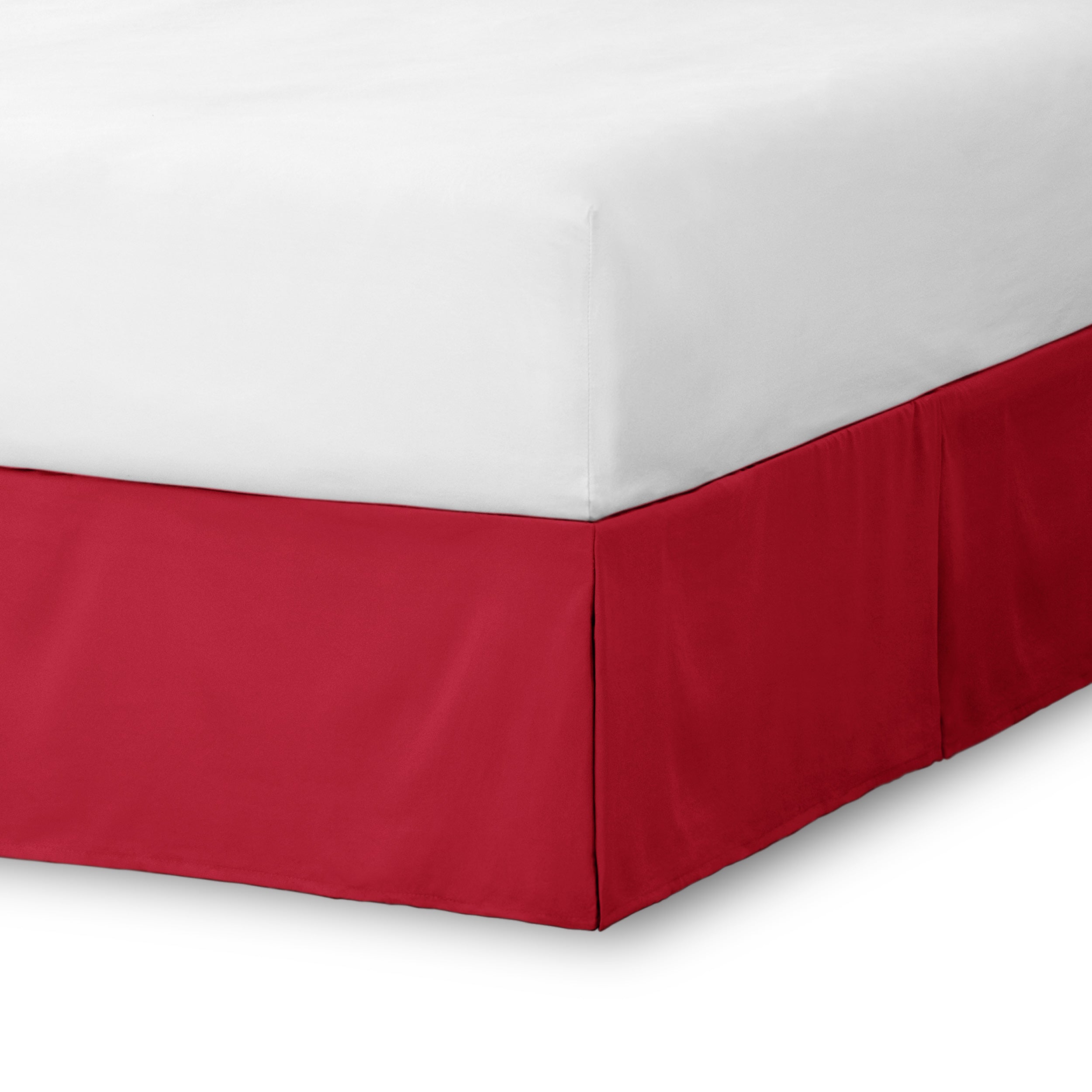 The corner of a bed skirt on a bed frame