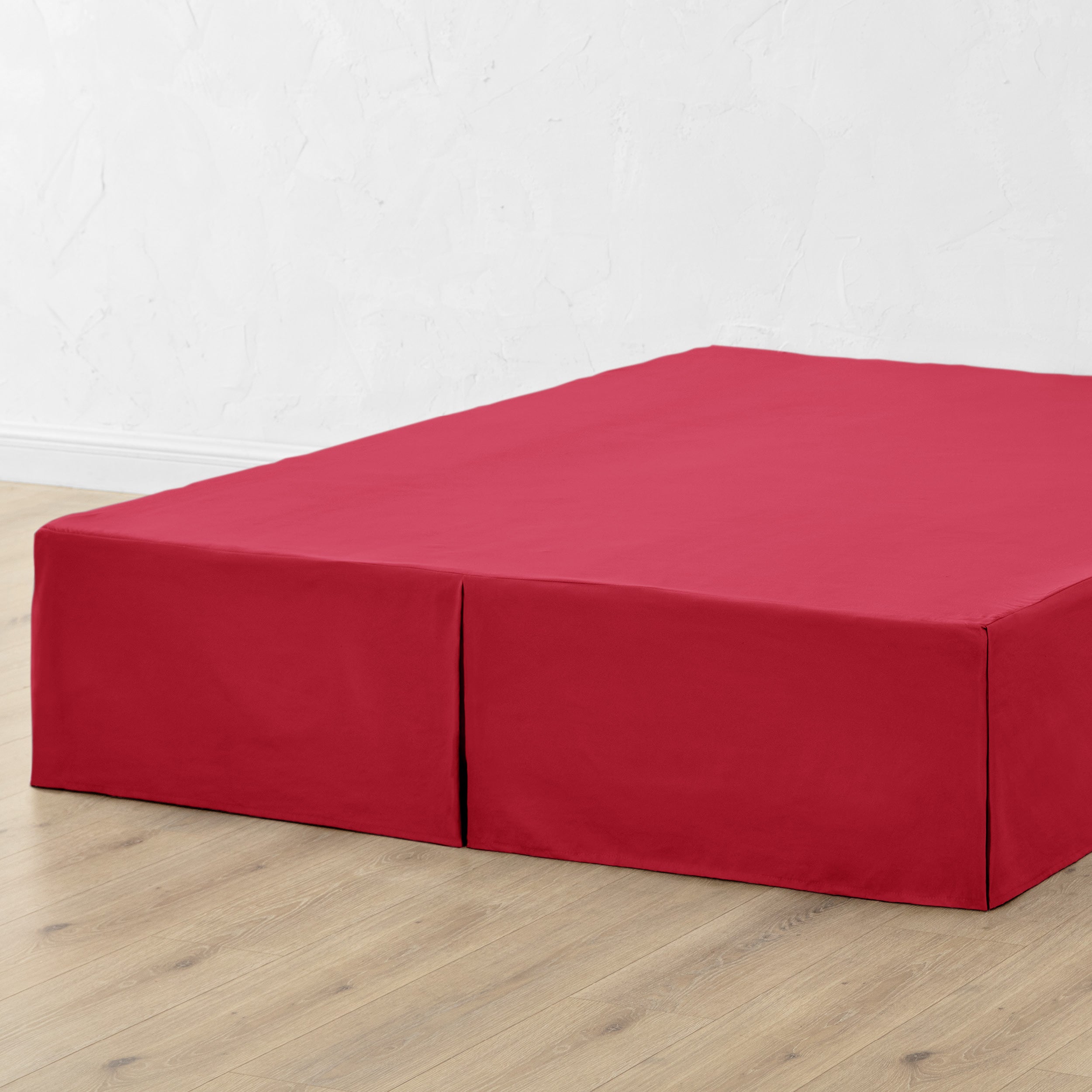 A bed skirt draped over a box spring