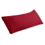 A body pillowcase on a pillow set against a headboard