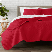 A quilted coverlet set on a bed