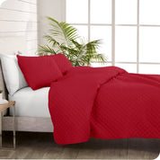 A coverlet set on a bed next to a window