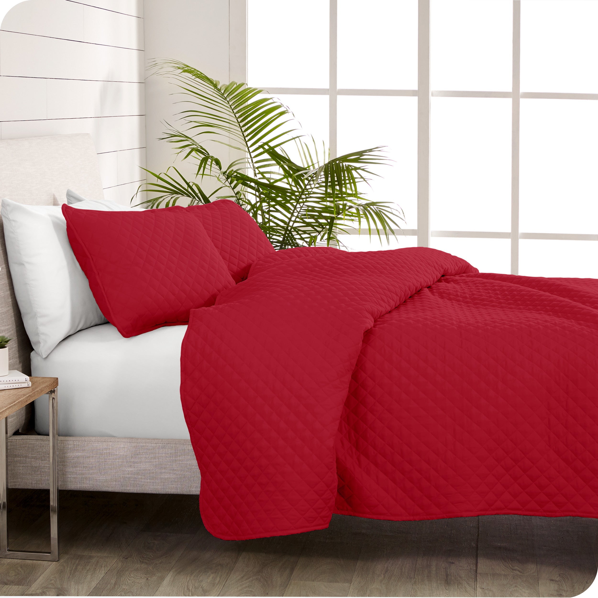 A coverlet set on a bed next to a window