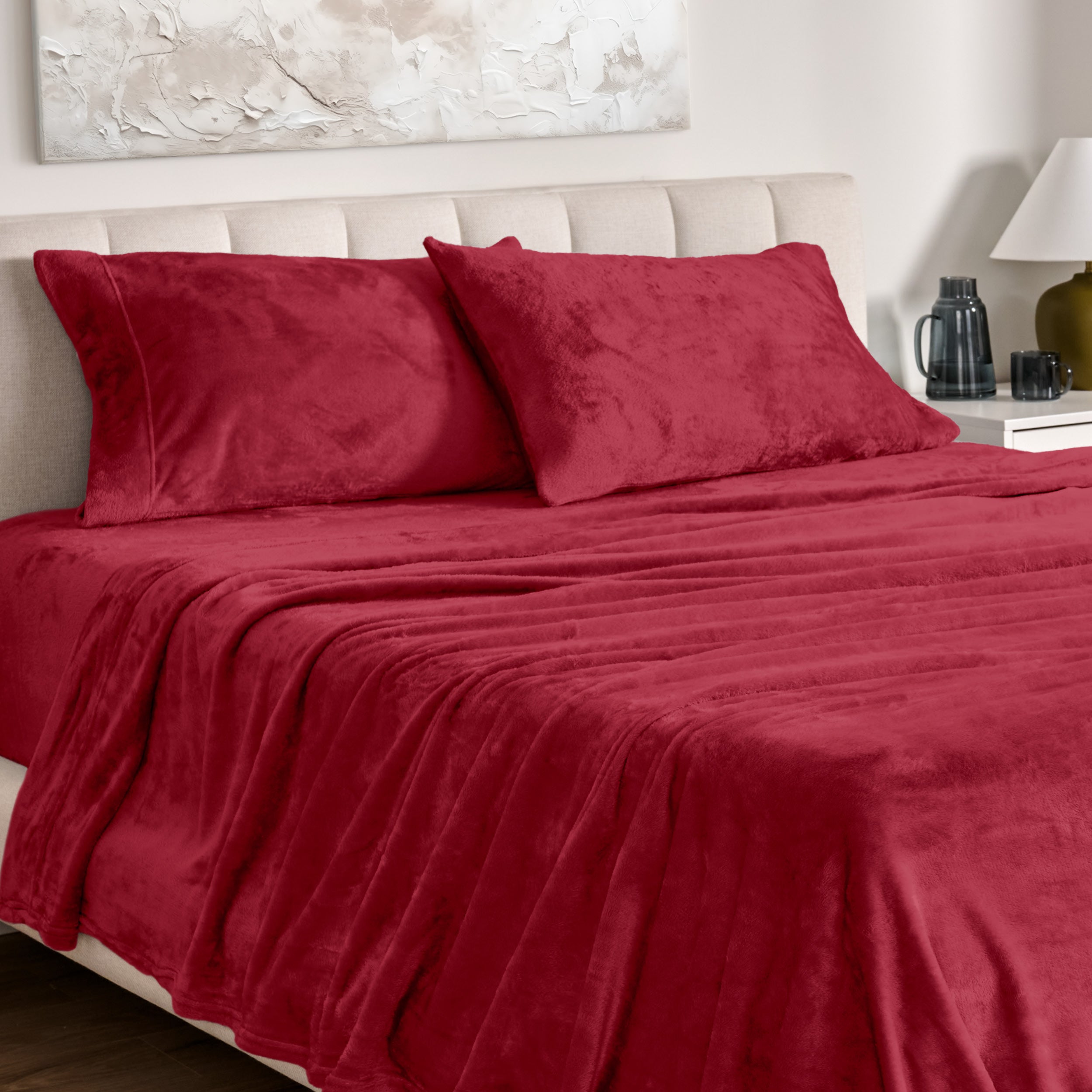Microplush bed sheets and pillowcases on a bed with a neutral headboard and decor.