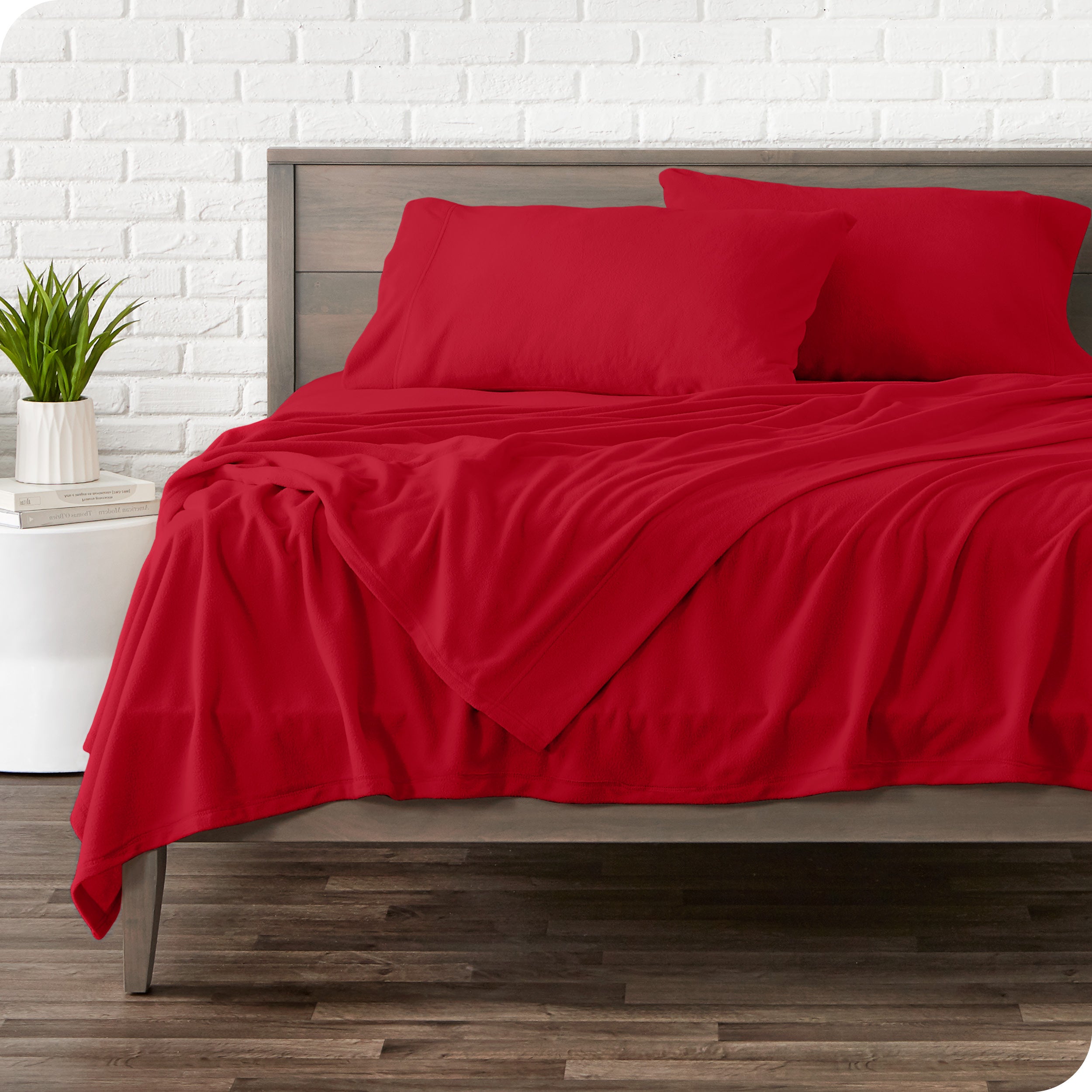 View of fleece sheets from the end of a bed with the top sheet draped over the side and end