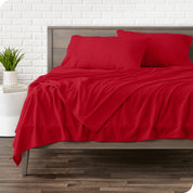View of fleece sheets from the end of a bed with the top sheet draped over the side and end