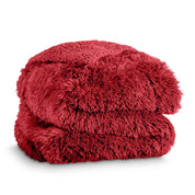 A shaggy faux fur blanket folded
