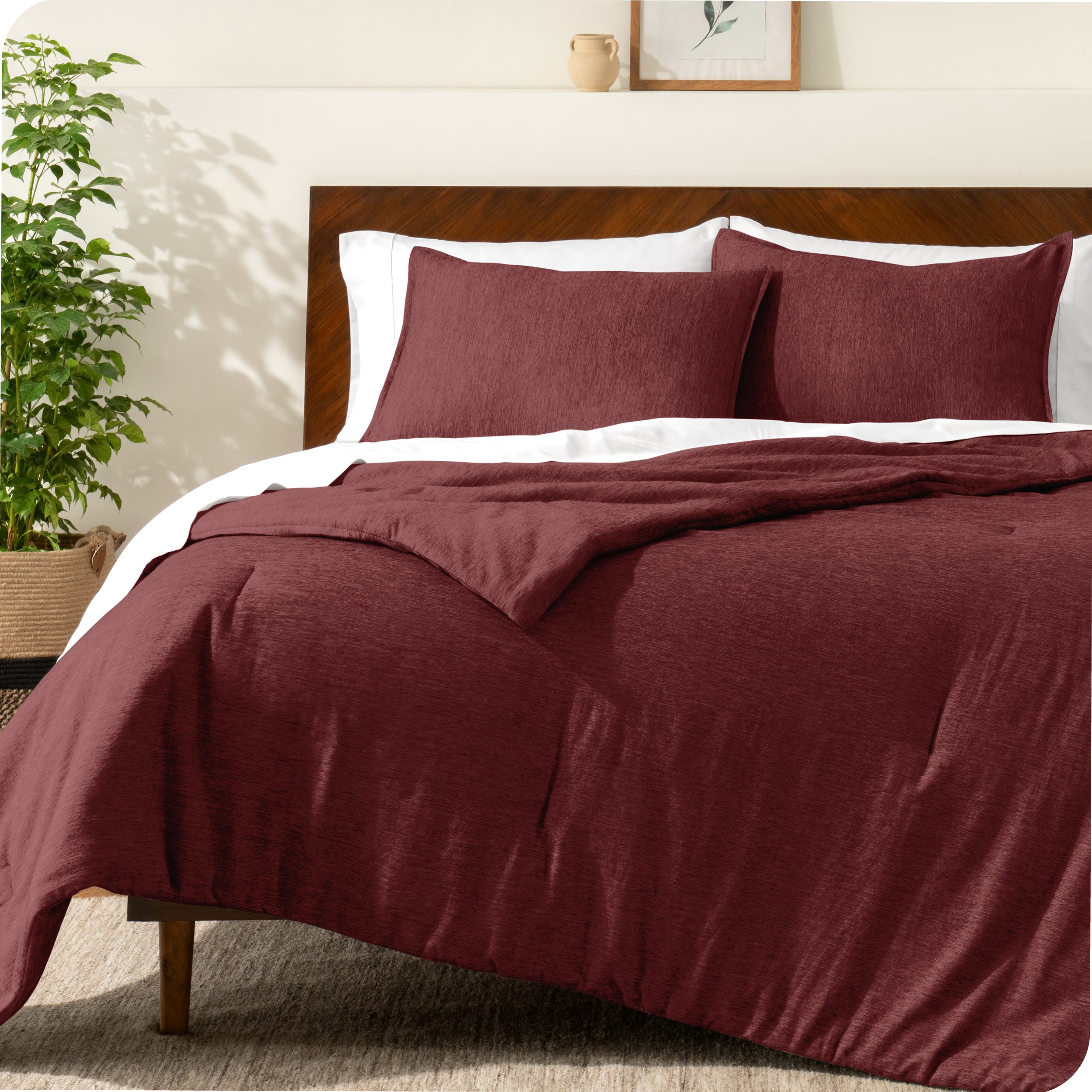 A modern bed with a down alternative comforter set on it
