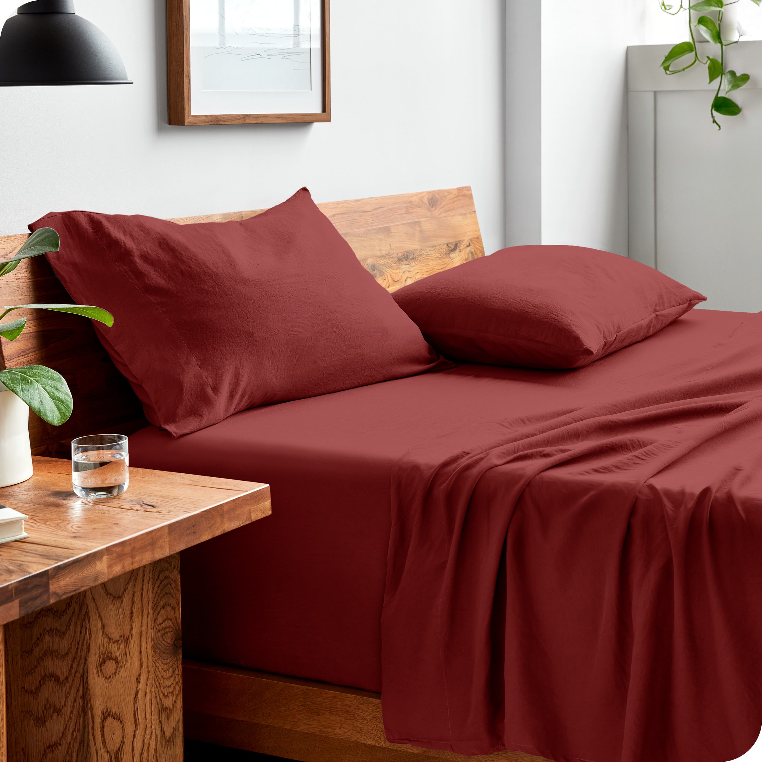 Side view of bed made with fitted sheet, pillowcases, and top sheet