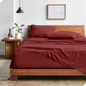 Modern bedroom with Sandwashed sheets draped over the end and side of mattress
