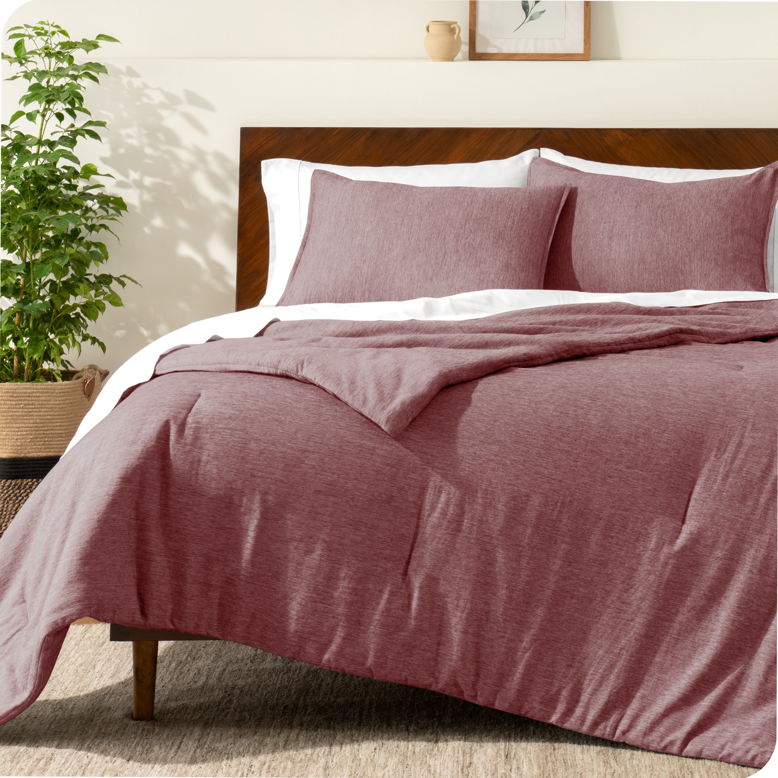 A modern bed with a down alternative comforter set on it
