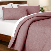 A side view of a modern bed with a comforter set and pillow shams on the bed
