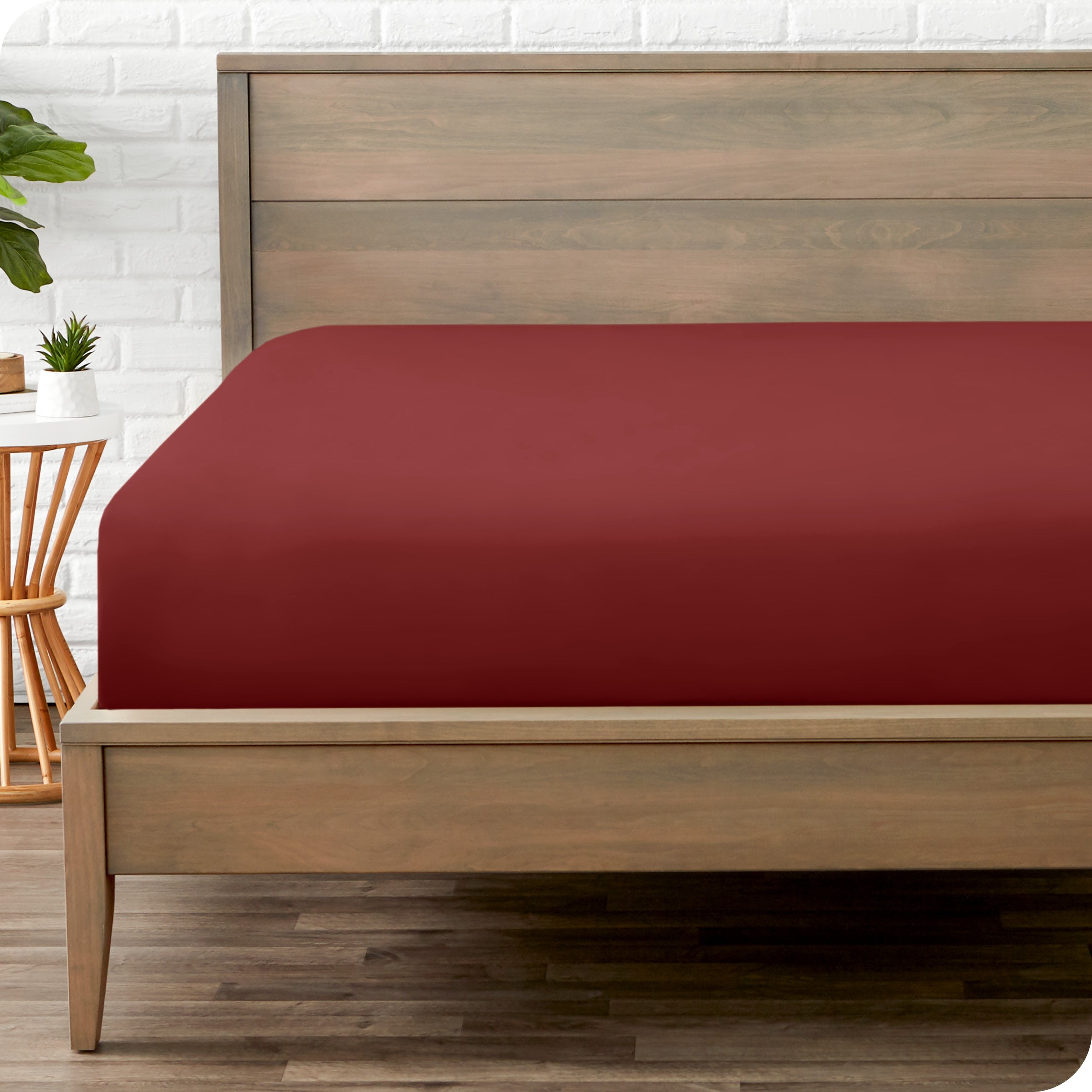 End of bed view with fitted sheet made on the mattress of a modern bed. 