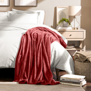 Microplush blanket laid out over a bed and folded back over itself