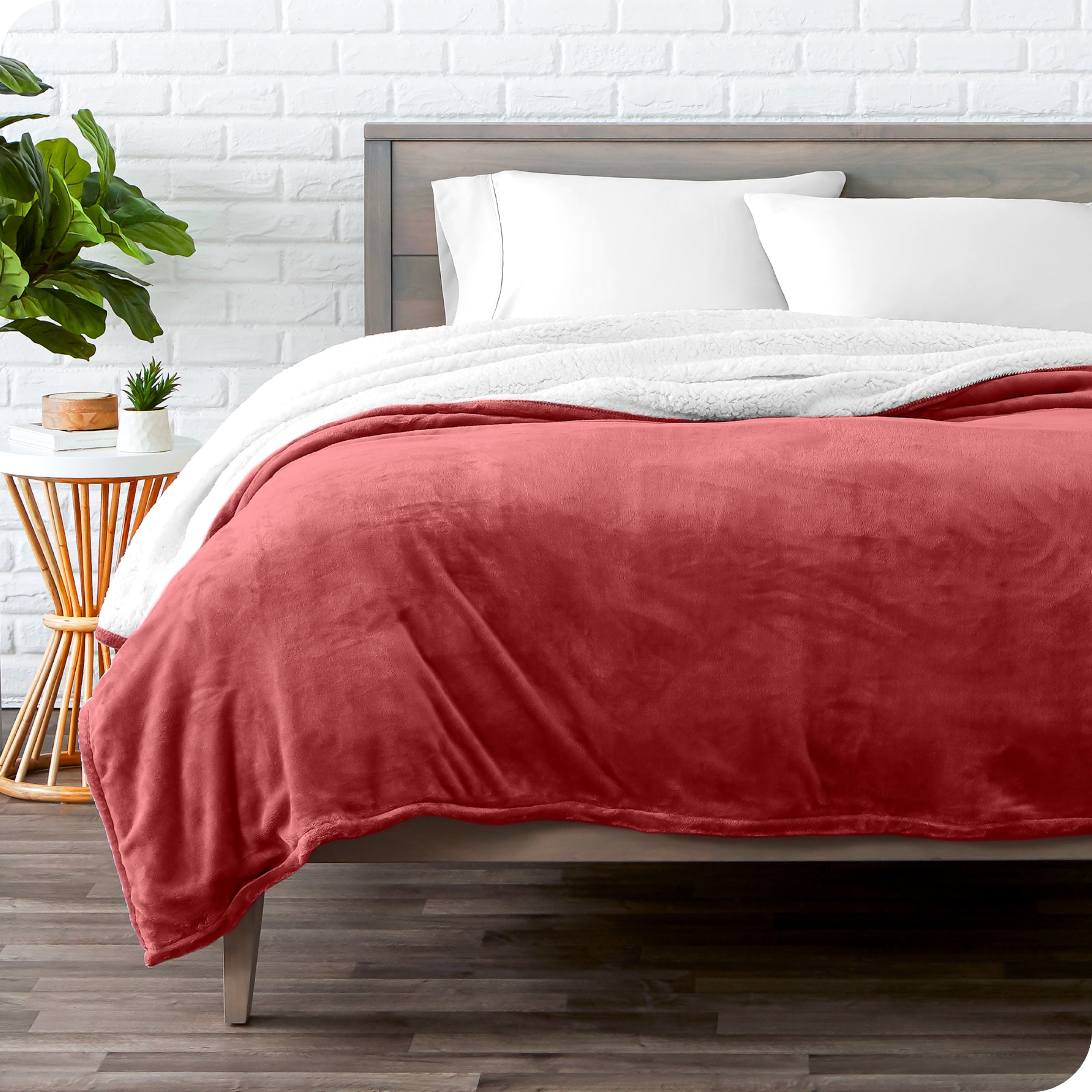 Rosewood Sherpa Blanket laying on a bed folded over itself part way
