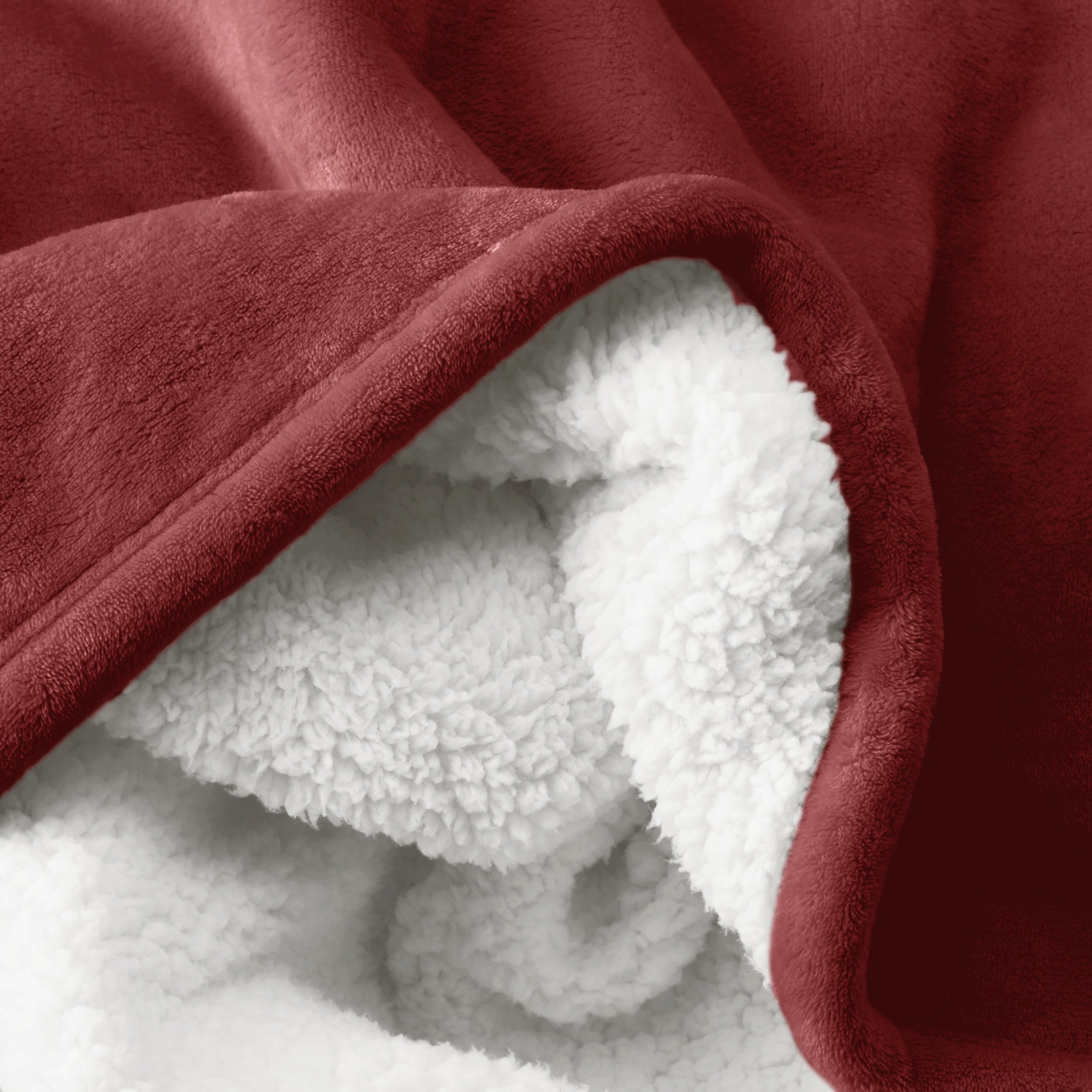 Close up of sherpa blanket showing texture of velvety soft side and sherpa backing