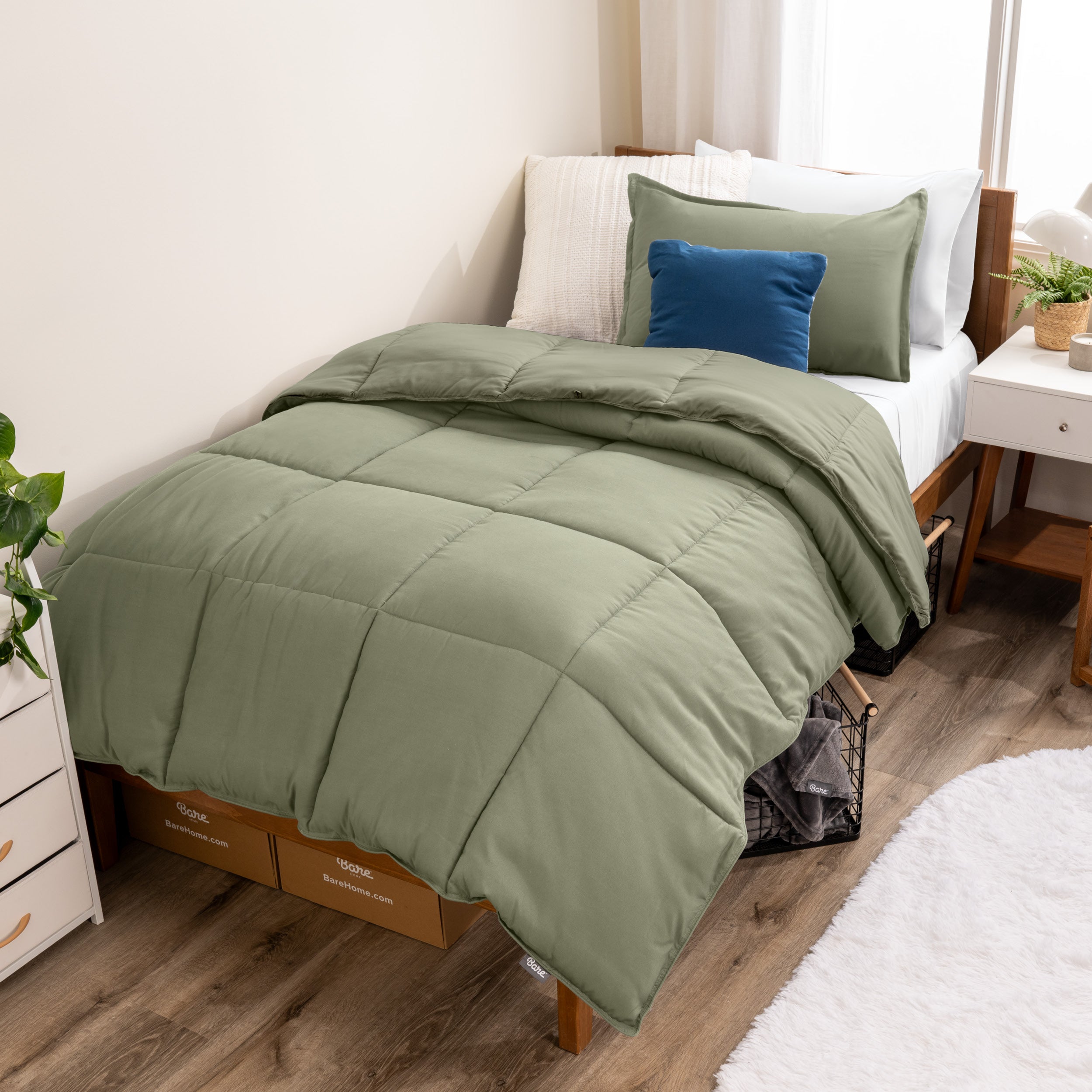 A modern bed with a down alternative comforter set on it