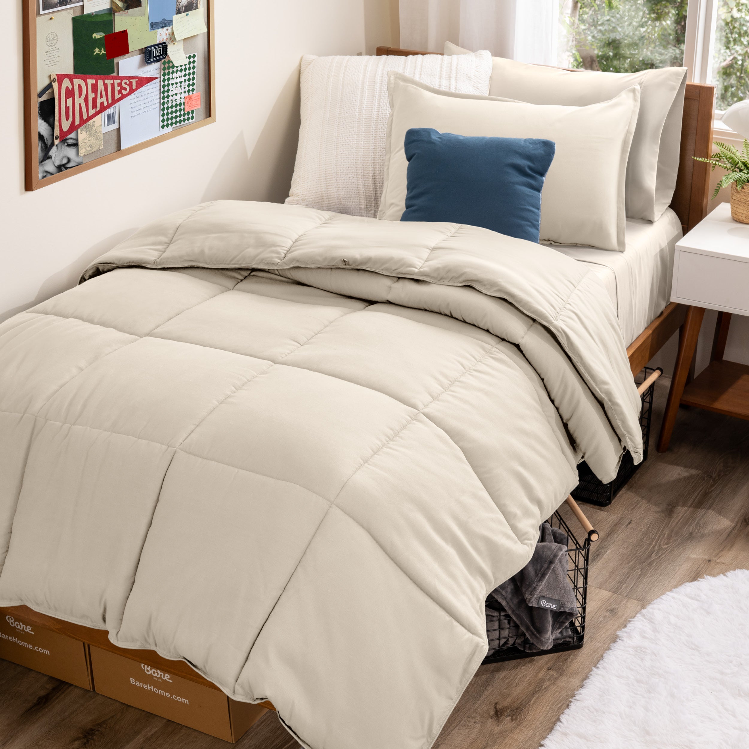 A college dorm room with a bed in a bag set on the mattress