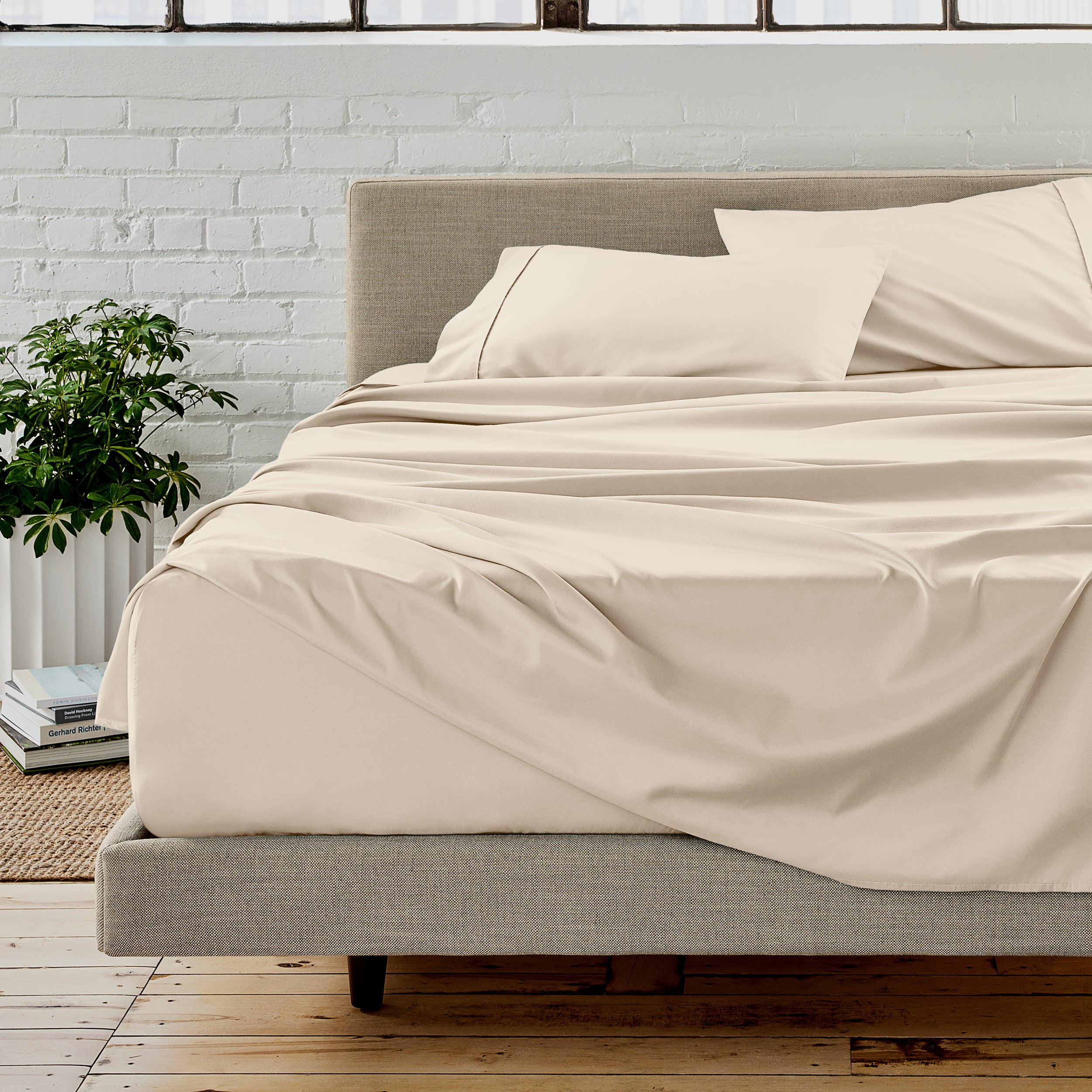 Microfiber sheet set on a bed with a white brick wall in the background