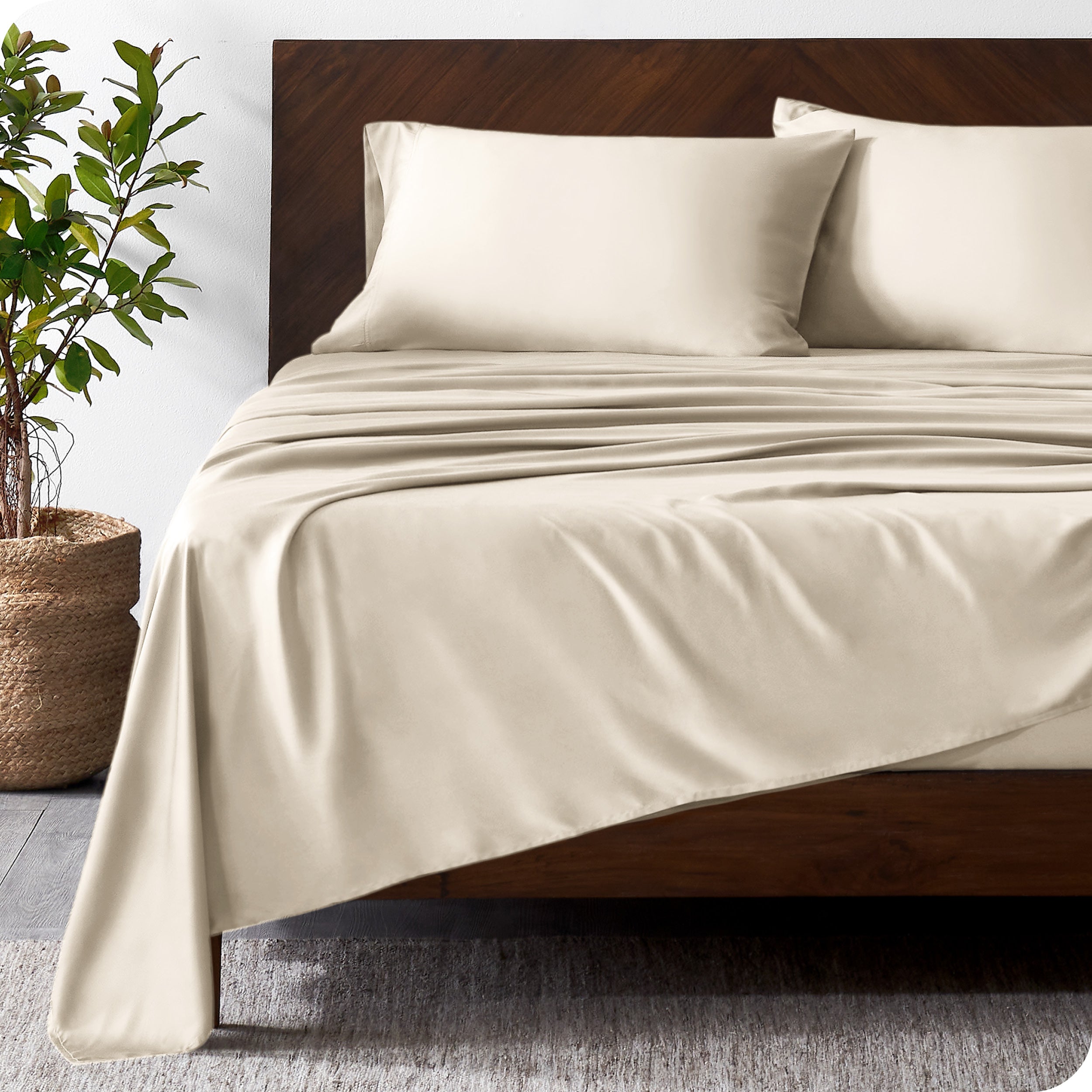 Wooden bed frame with bamboo sheets on the bed