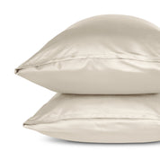 Two pillows with pillowcases stacked on a white background