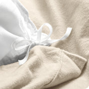 A folded stack of a flannel duvet cover with two pillows on top.
