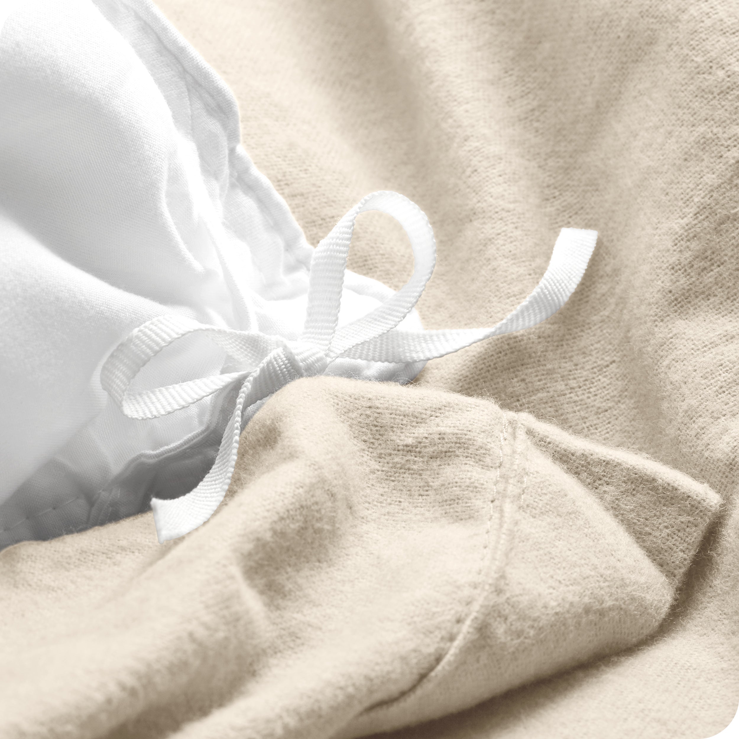 A folded stack of a flannel duvet cover with two pillows on top.
