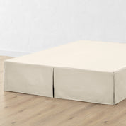 A bed skirt draped over a box spring